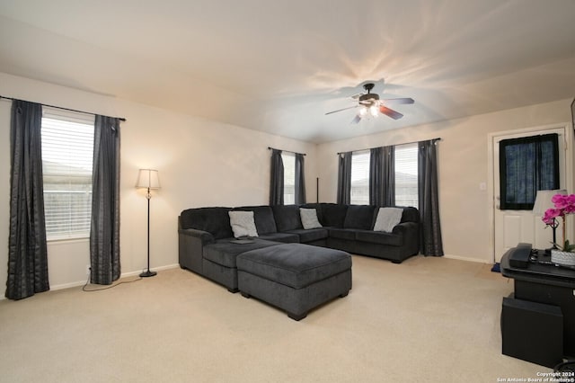 living room with light colored carpet, a wealth of natural light, and ceiling fan