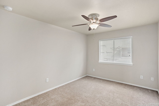 spare room featuring carpet flooring and ceiling fan