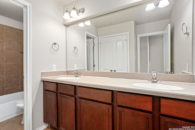 full bathroom featuring tile patterned floors, vanity, toilet, and shower / washtub combination