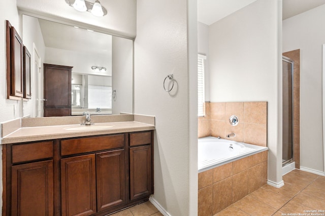 bathroom with tile patterned floors, vanity, and plus walk in shower