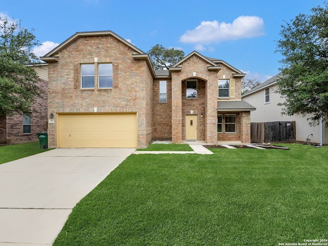 front facade featuring a front yard and a garage