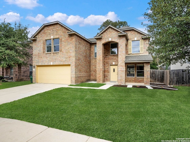 view of front of home with a front yard and a garage