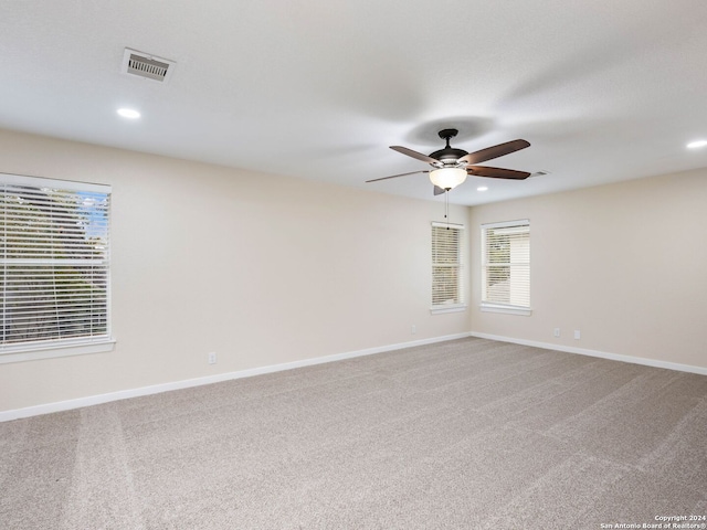 carpeted empty room featuring ceiling fan