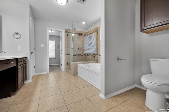 full bathroom with tile patterned flooring, vanity, separate shower and tub, and toilet