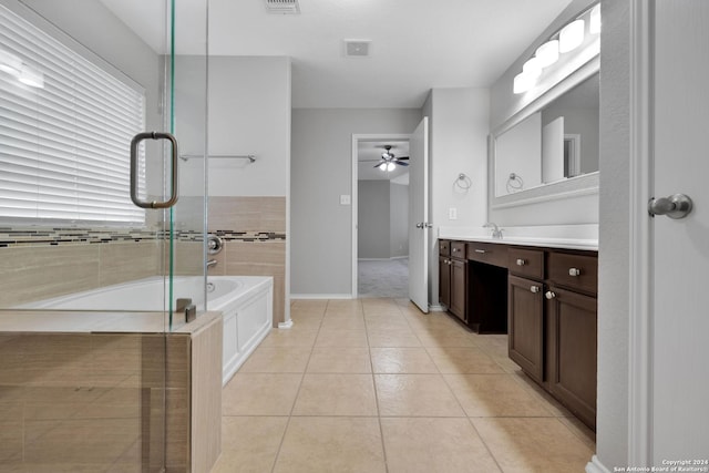 bathroom with tile patterned floors, ceiling fan, a tub to relax in, and vanity