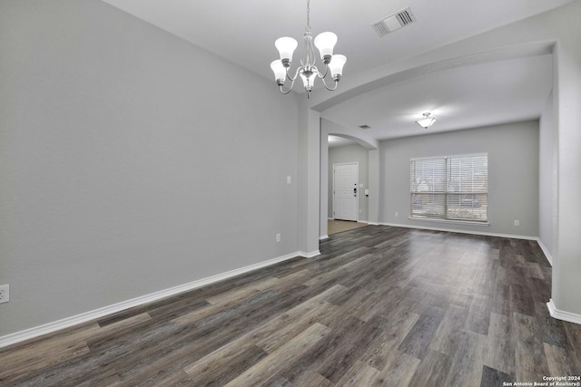 interior space with dark wood-type flooring and a notable chandelier