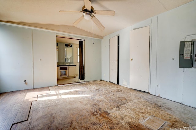 unfurnished room featuring electric panel, ceiling fan, lofted ceiling, and light wood-type flooring