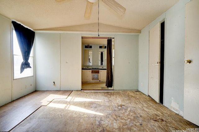 unfurnished room featuring ceiling fan and vaulted ceiling