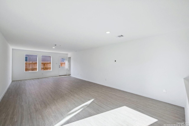 spare room with light hardwood / wood-style flooring