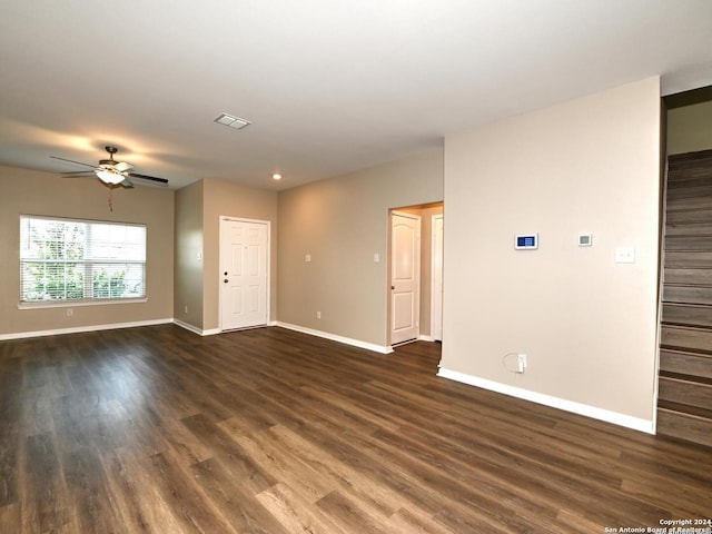 empty room with dark hardwood / wood-style floors and ceiling fan