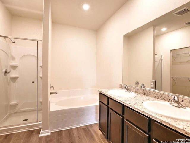 bathroom featuring separate shower and tub, vanity, and hardwood / wood-style flooring