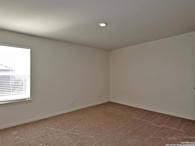 unfurnished room featuring carpet flooring