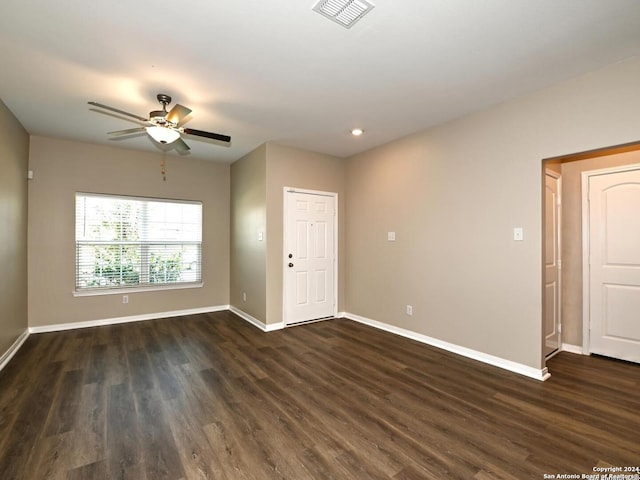 unfurnished room with ceiling fan and dark hardwood / wood-style flooring