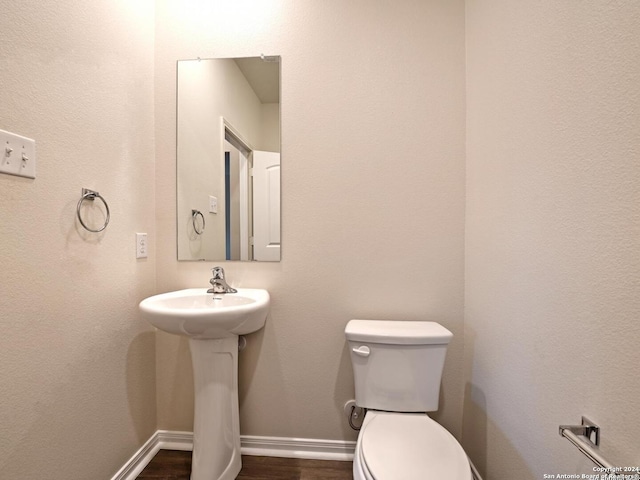 bathroom featuring hardwood / wood-style floors, toilet, and sink