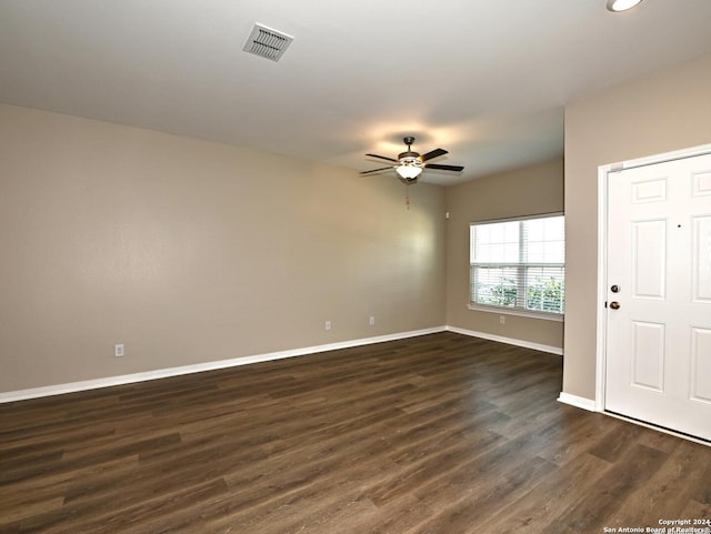 empty room featuring ceiling fan and dark wood-type flooring