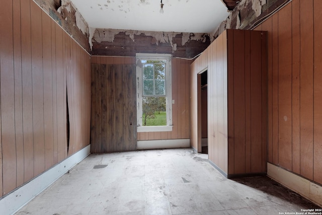 empty room featuring wood walls