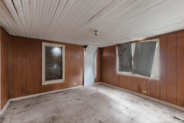 empty room with wooden walls and wood ceiling