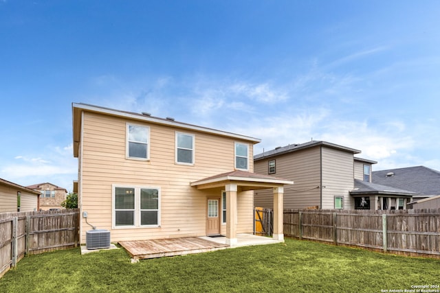 back of house featuring a wooden deck, a yard, and central AC unit