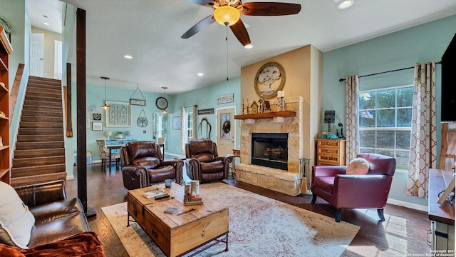 living room with ceiling fan, a fireplace, and wood-type flooring