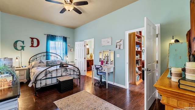 bedroom featuring connected bathroom, dark hardwood / wood-style floors, and ceiling fan