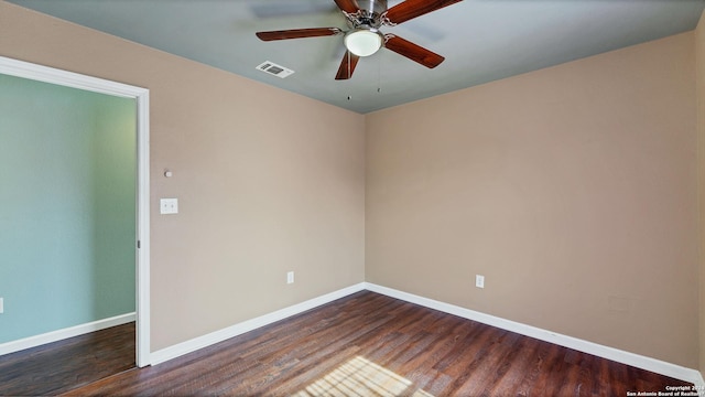 spare room featuring ceiling fan and dark wood-type flooring