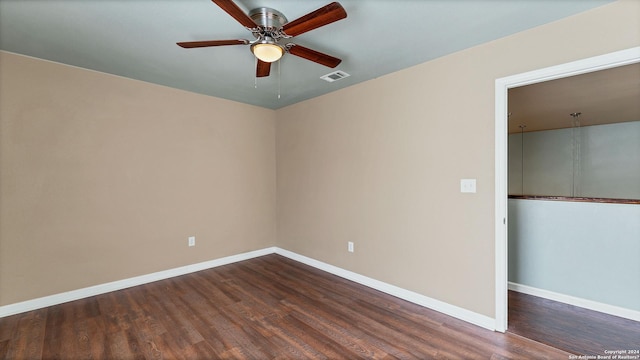 empty room featuring dark hardwood / wood-style floors and ceiling fan