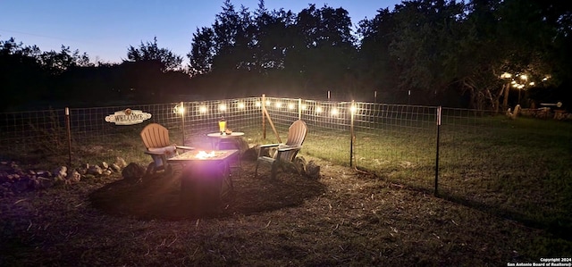 yard at dusk with a fire pit