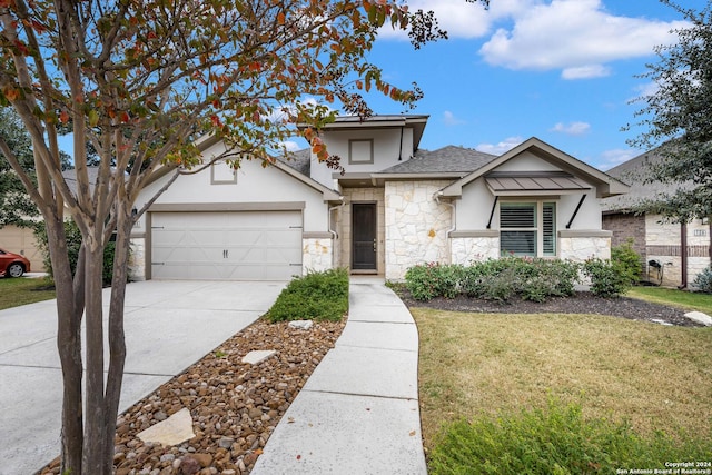 view of front of property with a garage and a front lawn