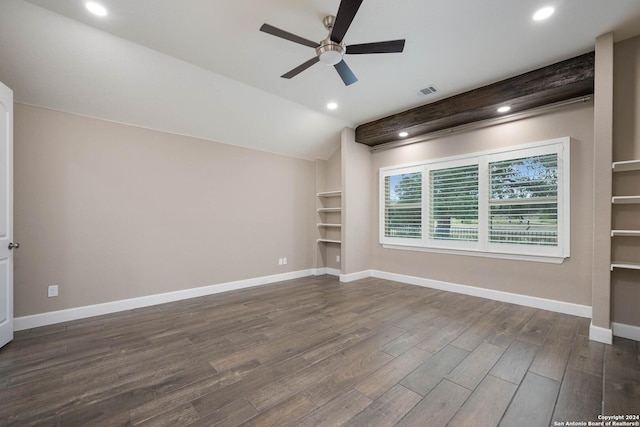 spare room with dark hardwood / wood-style flooring, vaulted ceiling, and ceiling fan