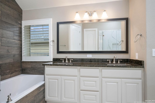 bathroom with vanity and independent shower and bath