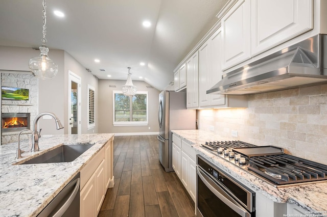 kitchen featuring white cabinets, sink, decorative backsplash, appliances with stainless steel finishes, and dark hardwood / wood-style flooring