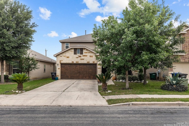 view of front of home with a front yard and a garage