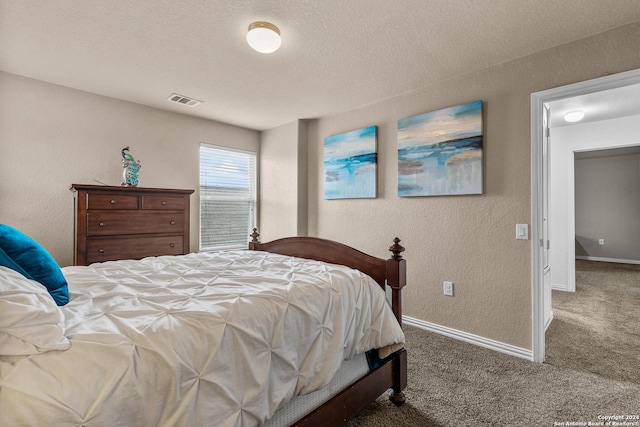 bedroom featuring carpet flooring and a textured ceiling