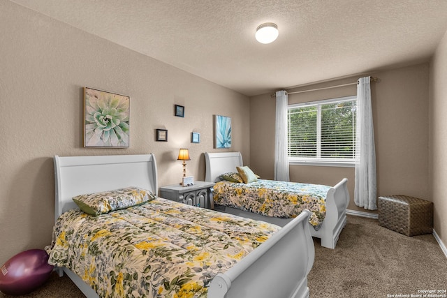 bedroom featuring light colored carpet and a textured ceiling