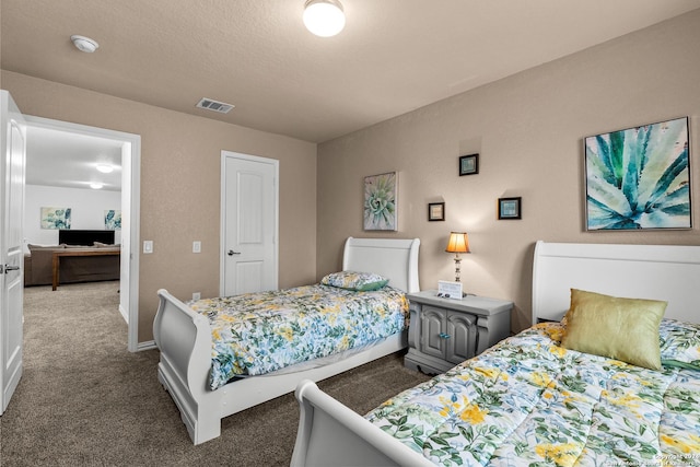 bedroom with carpet flooring and a textured ceiling