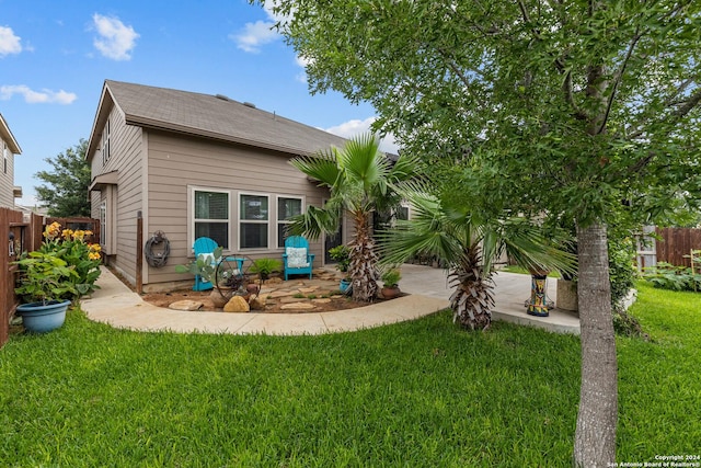 rear view of property with a lawn