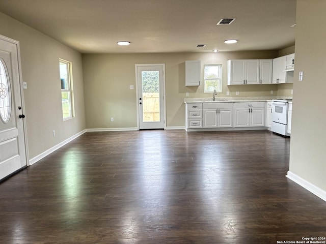 kitchen with white range oven, white cabinetry, sink, and dark wood-type flooring