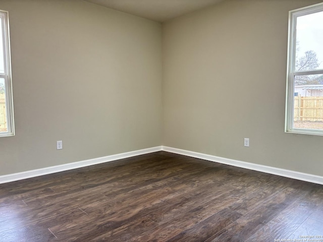 unfurnished room with dark hardwood / wood-style floors