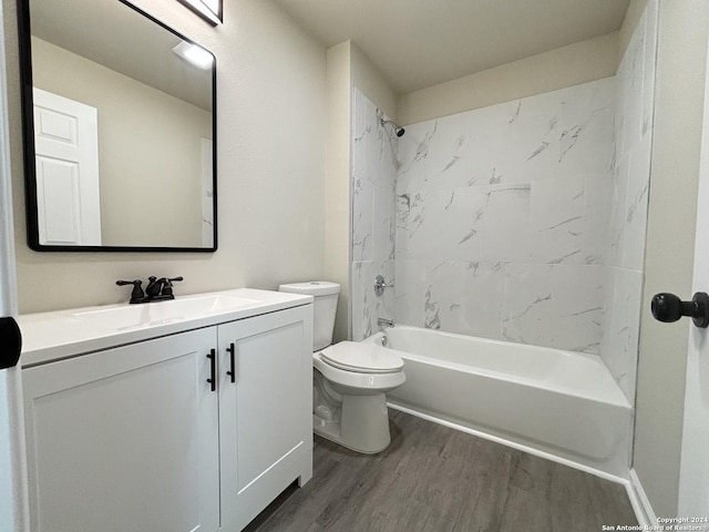 full bathroom featuring hardwood / wood-style flooring, vanity, toilet, and tiled shower / bath