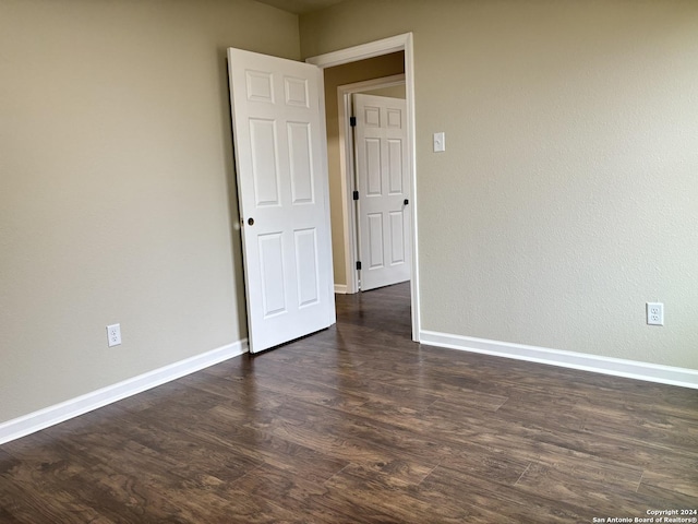 spare room featuring dark hardwood / wood-style flooring