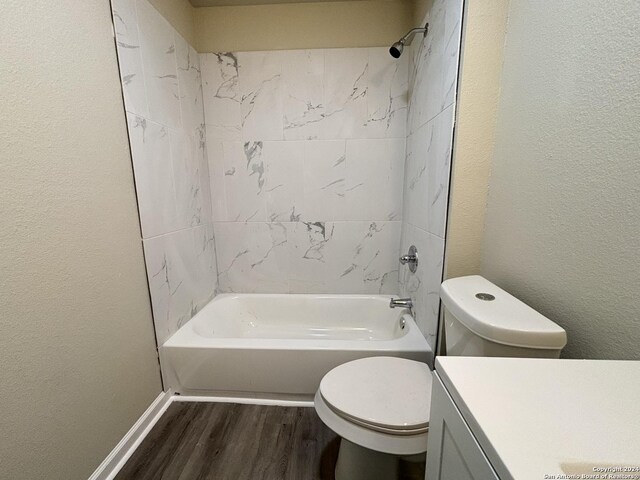 full bathroom featuring wood-type flooring, vanity, toilet, and tiled shower / bath