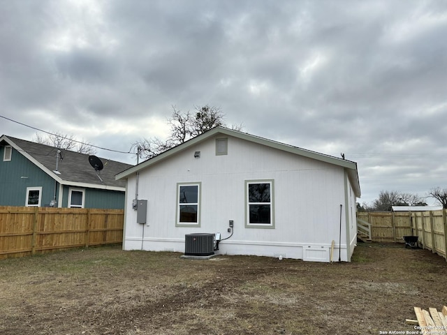 rear view of property with cooling unit