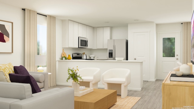 kitchen featuring appliances with stainless steel finishes, white cabinetry, and light hardwood / wood-style flooring