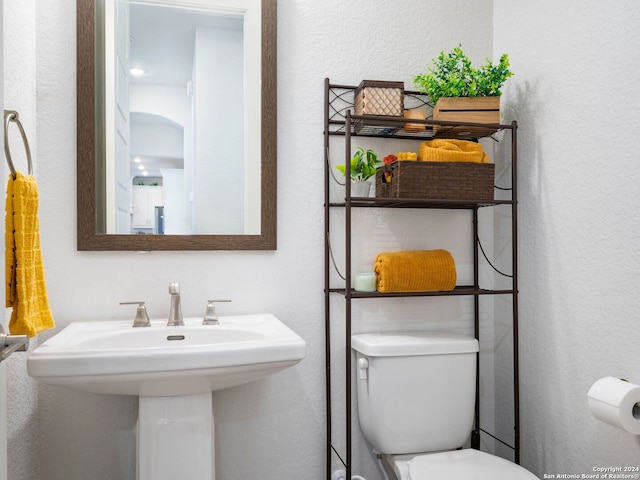 bathroom with toilet and sink