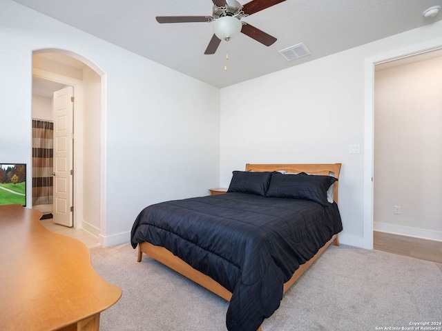 bedroom with ceiling fan and light colored carpet