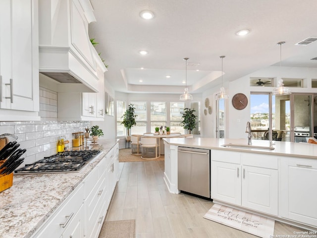 kitchen with a healthy amount of sunlight, white cabinetry, and stainless steel appliances