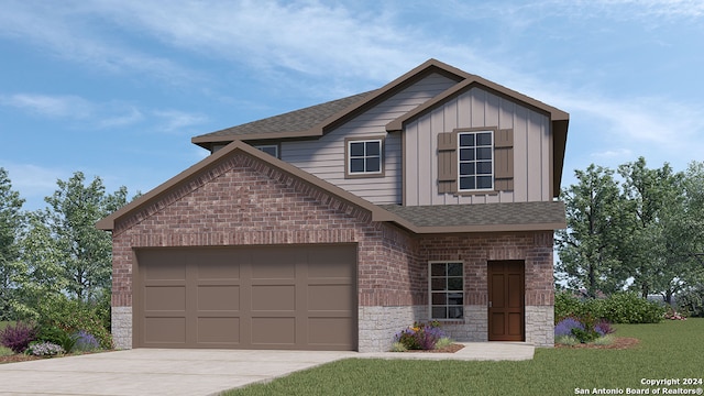 view of front of home with a front yard and a garage