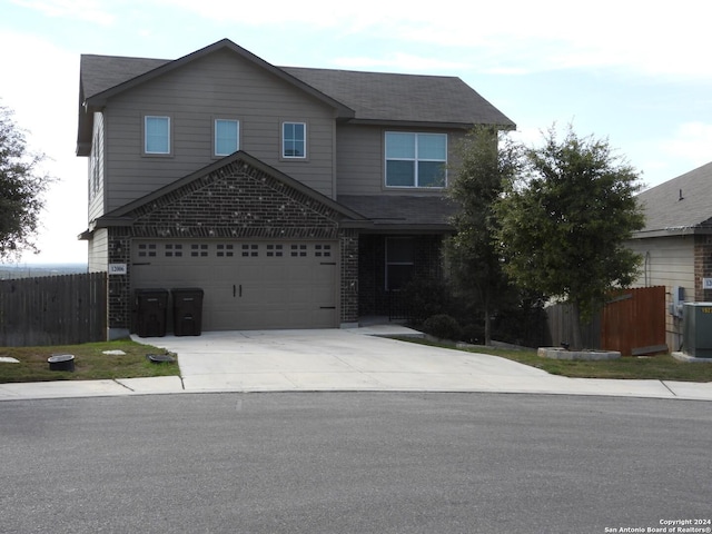 front of property with a garage and central air condition unit