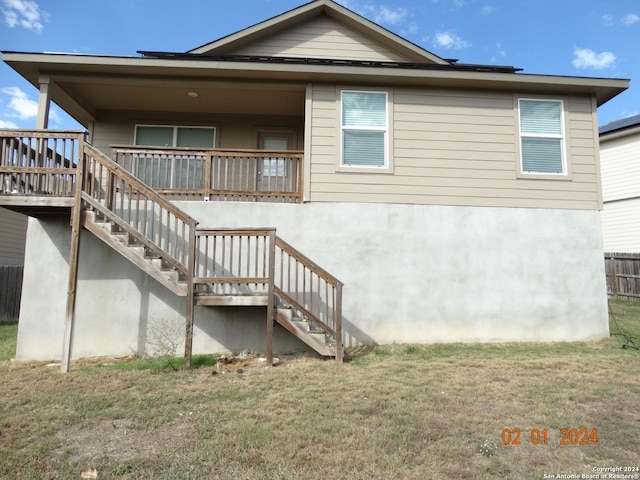 rear view of house with a yard