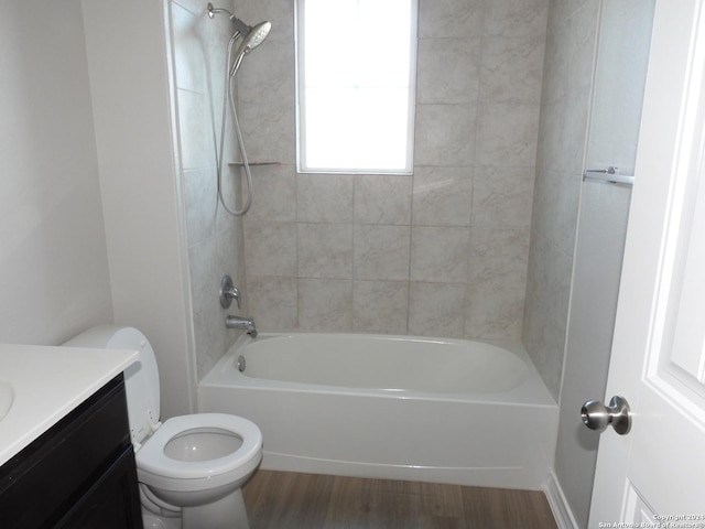 full bathroom with hardwood / wood-style floors, vanity, toilet, and tiled shower / bath combo